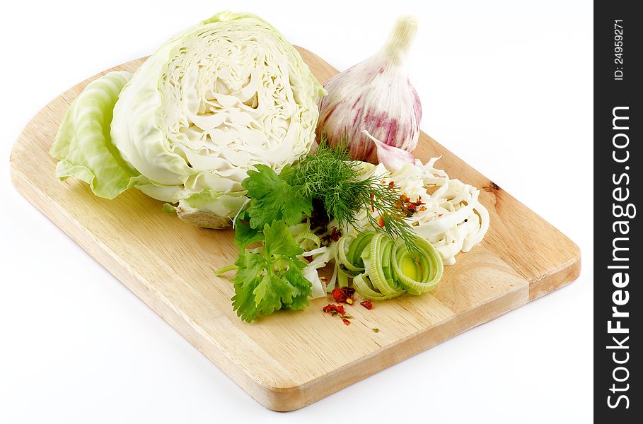 Set of cabbage and raw vegetables close up on wooden background