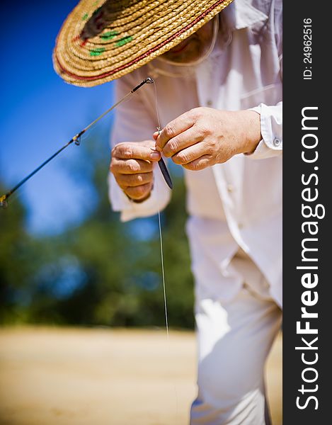 Fisherman preparing the rod for start fishing