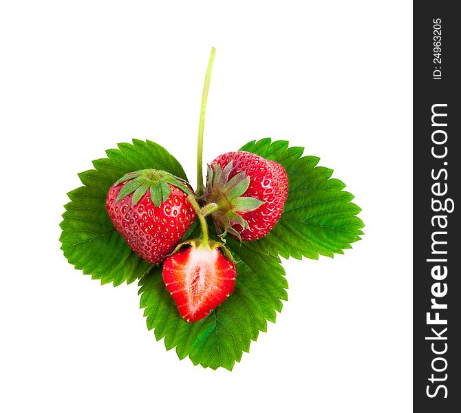 Whole and half strawberries on green leaves isolated on white background