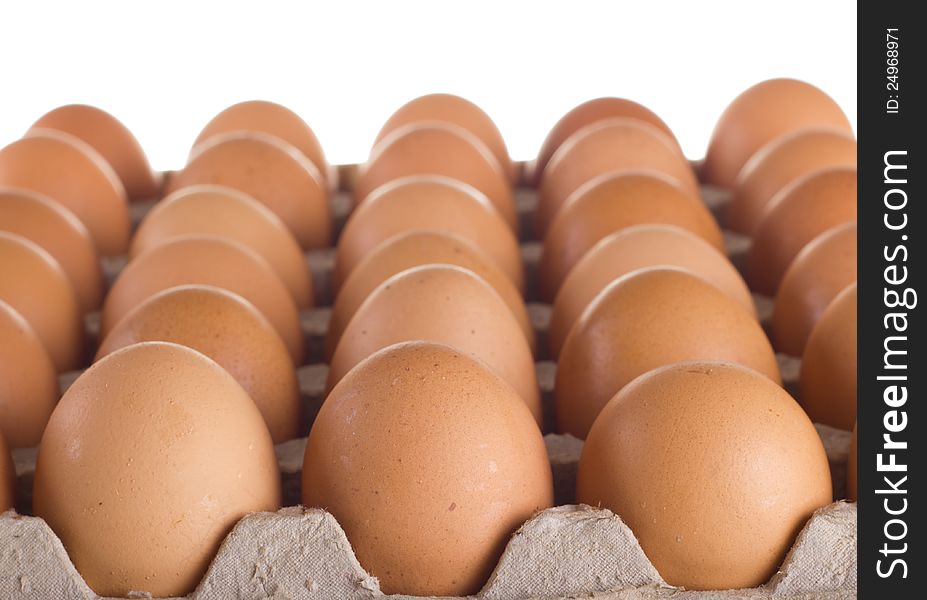 Carton of fresh brown eggs on white background