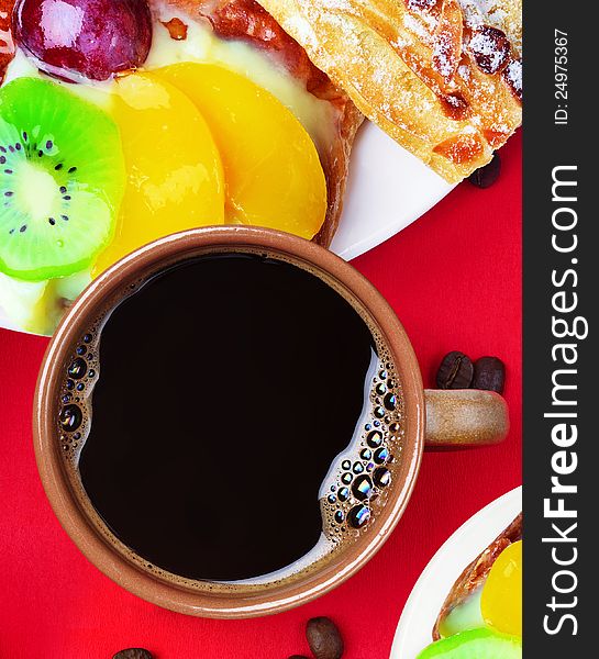 Cup of coffee and cakes with fruits