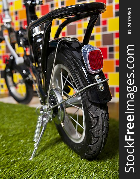 Black small bicycle on colorful background