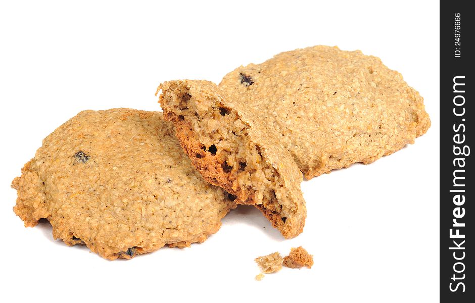 Crispy homemade raisin oatmeal cookies with crumbs  on a white background