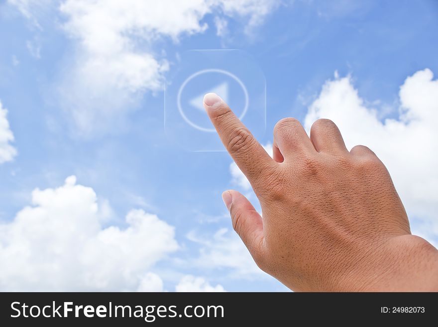 Hand pressing button with Sky background