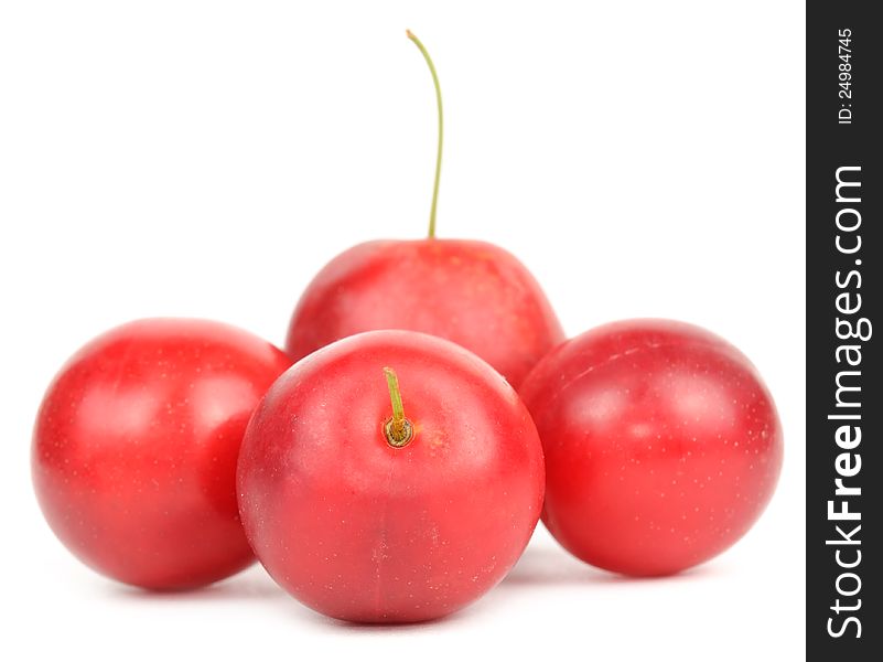 Red cherry plums on a white background