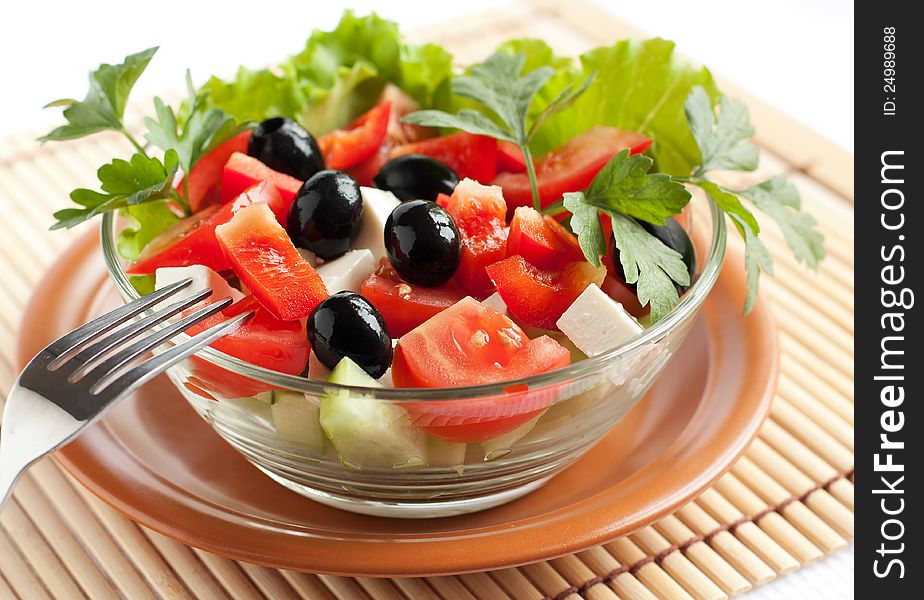 Fresh Greek salad in a glass bowl