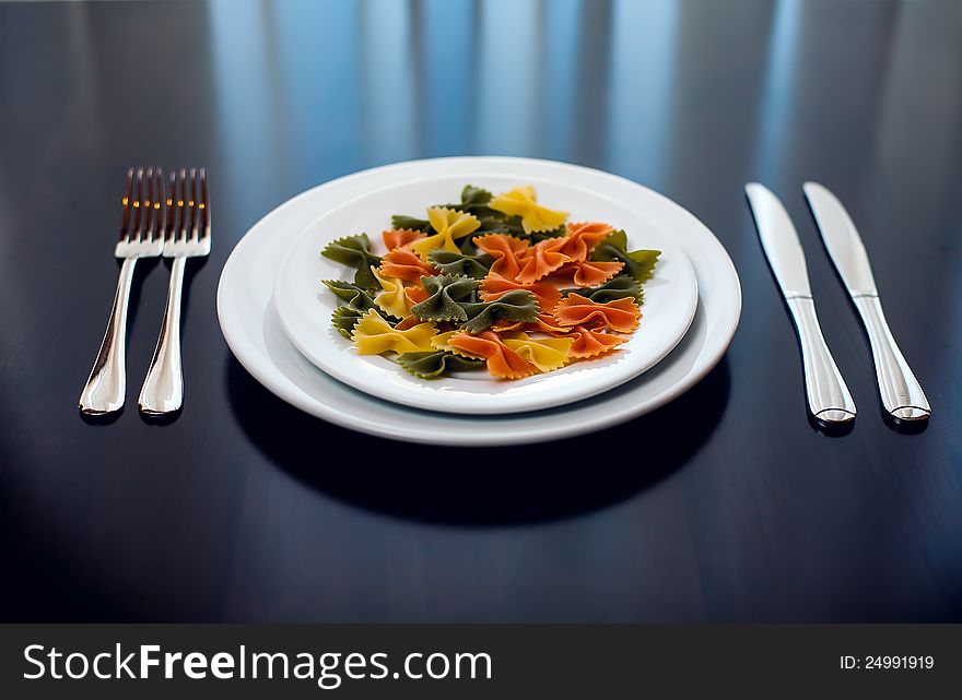 Pasta in the form of ribbons on the plate. Pasta in the form of ribbons on the plate