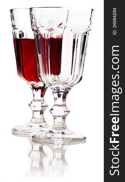 Glass of red wine and empty glass with reflection on a white background. Glass of red wine and empty glass with reflection on a white background.