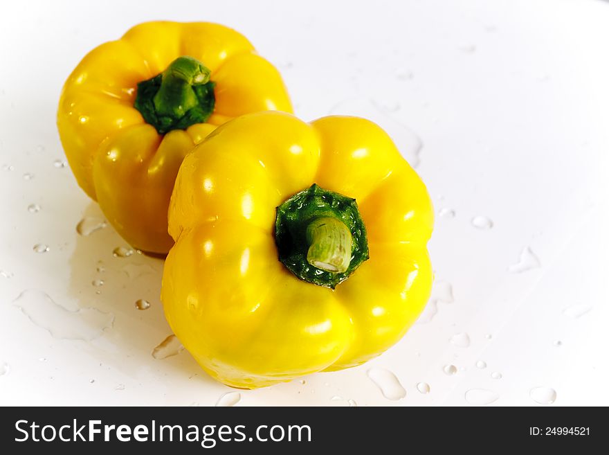 Two yellow peppers with water droplets. Two yellow peppers with water droplets