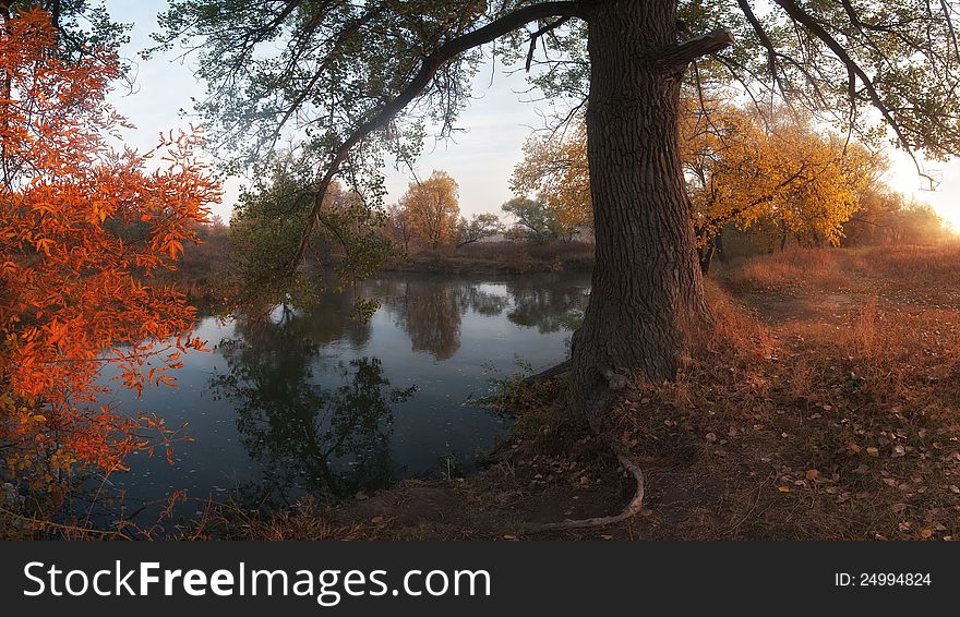 Beautiful autumn landscape on coast of the river, foggy morning with sun. Panorama. Beautiful autumn landscape on coast of the river, foggy morning with sun. Panorama