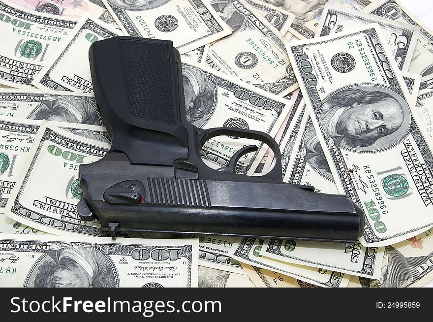 Automatic pistol lying on the U.S. currency. Automatic pistol lying on the U.S. currency