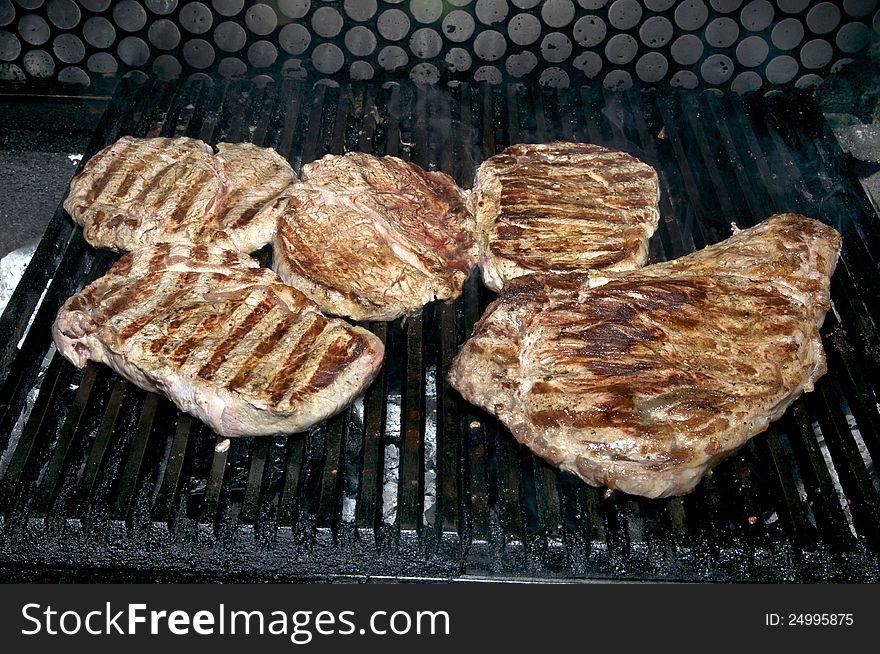 Steaks cooked on a grill in the restaurant