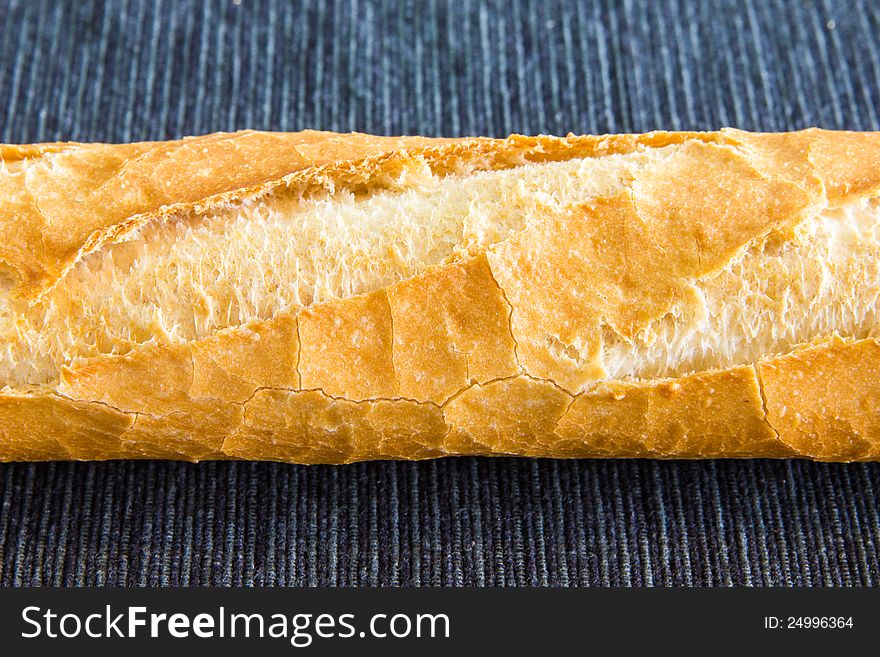 Closeup of french baguette over a black cloth. Closeup of french baguette over a black cloth