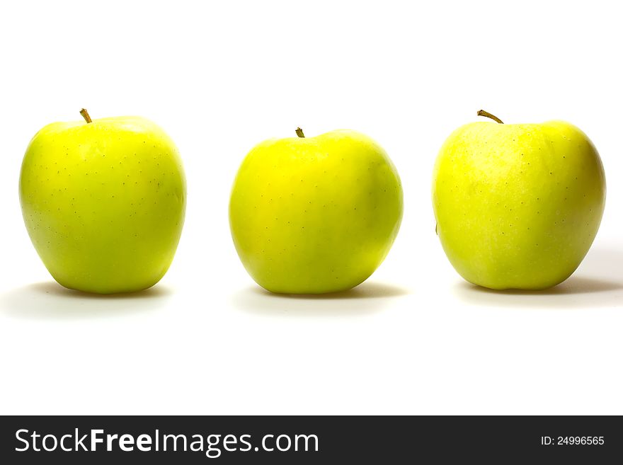 Three yellow-green apples in a row  on white background. Three yellow-green apples in a row  on white background.