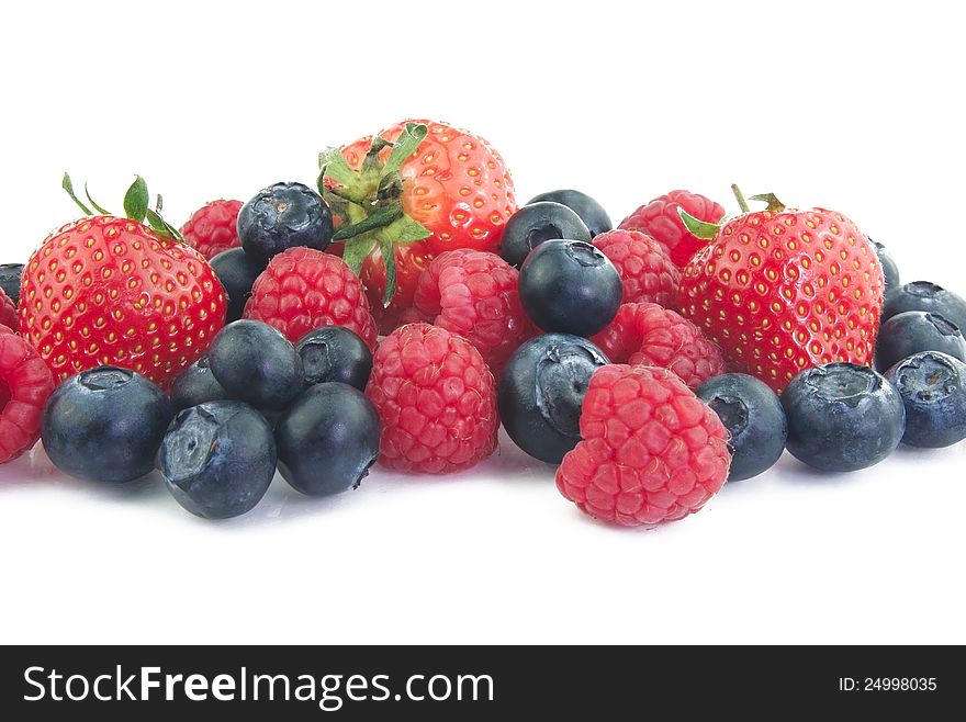 Blueberries, raspberries and strawberries on white background