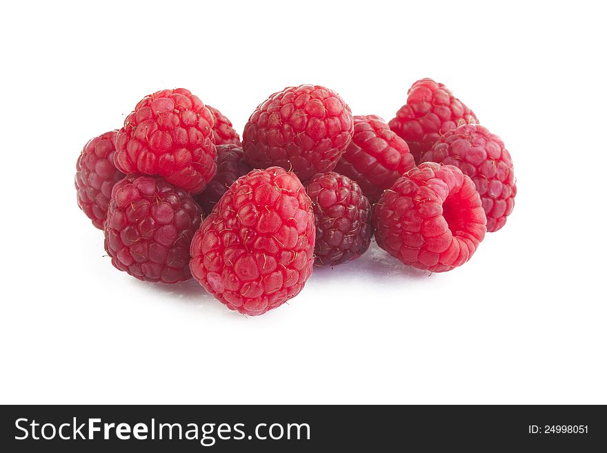 Few ripe raspberries on white background