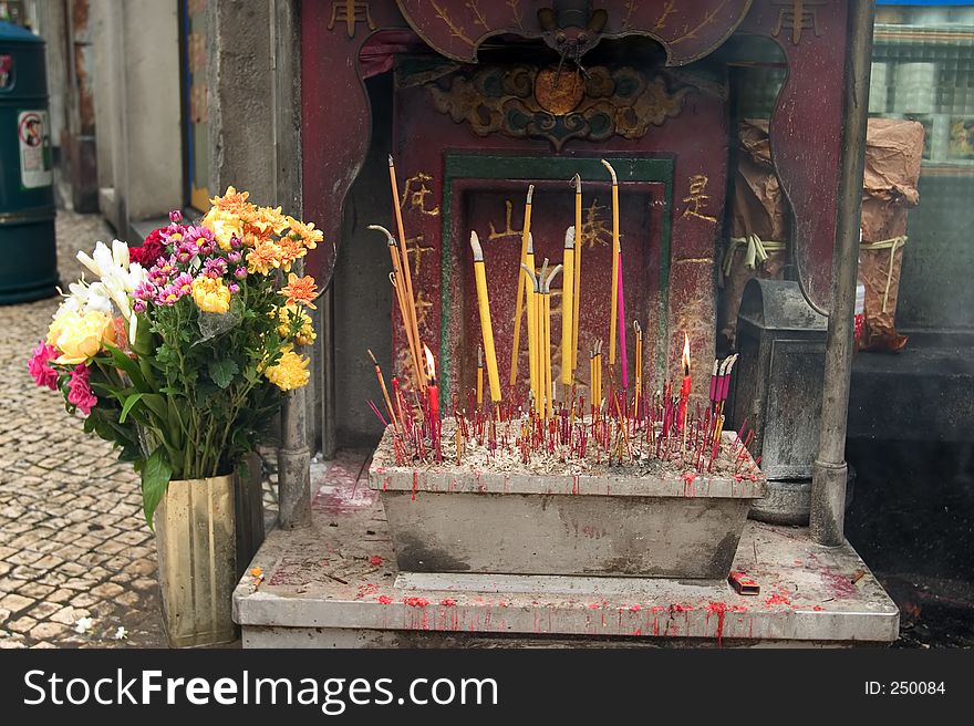 Joss sticks burn at a streetside altar in Macau, a Special Administrative Region of China.