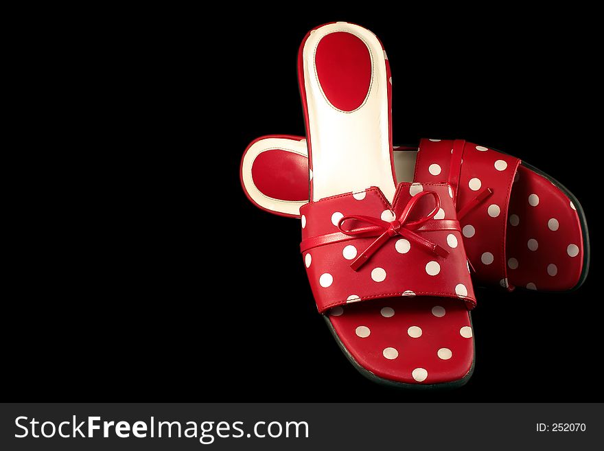 Red and white polka-dot shoes isolated on a black background. With clipping path. Red and white polka-dot shoes isolated on a black background. With clipping path.