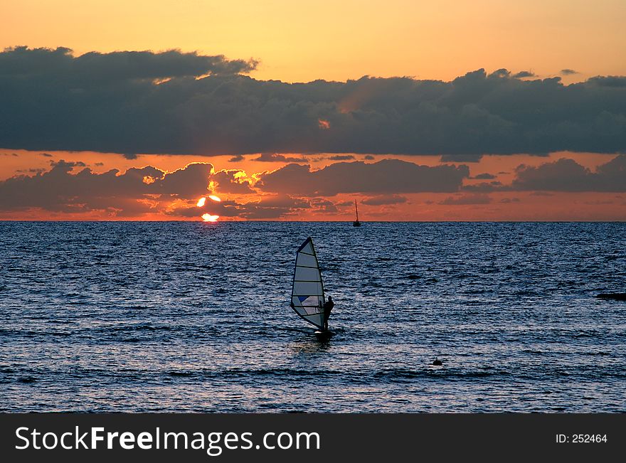 Windsurfer at sunset in the Mediteranien sez. Windsurfer at sunset in the Mediteranien sez