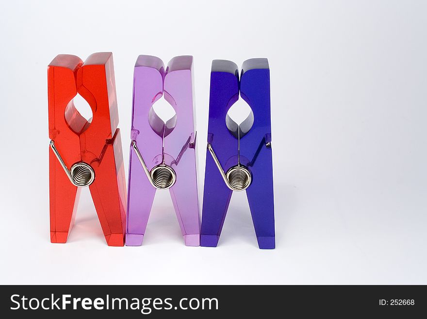 Row of 3 plastic clips against white background. Row of 3 plastic clips against white background