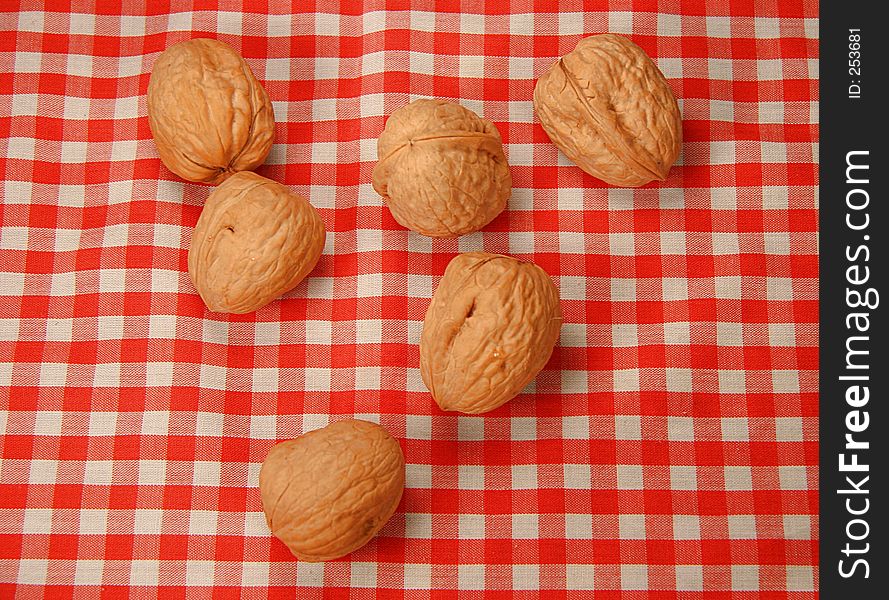 Six nuts over a tablecloth