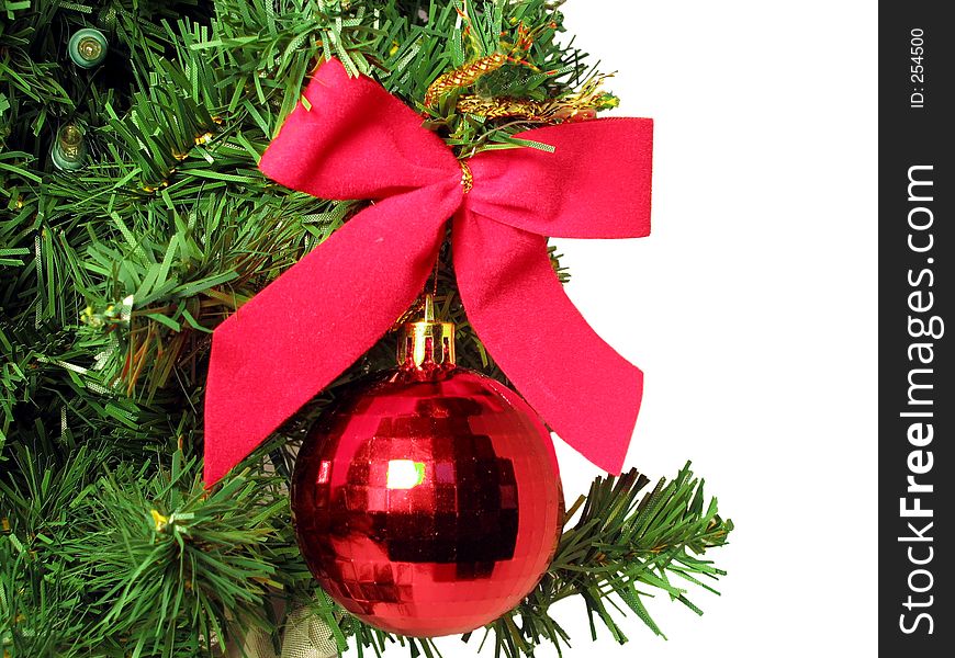 Red bow and round ornament hanging from Christmas Tree. Red bow and round ornament hanging from Christmas Tree