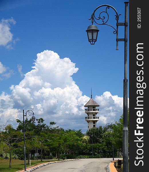 A road leading to a lighthouse with a clear blue sky background. A road leading to a lighthouse with a clear blue sky background.