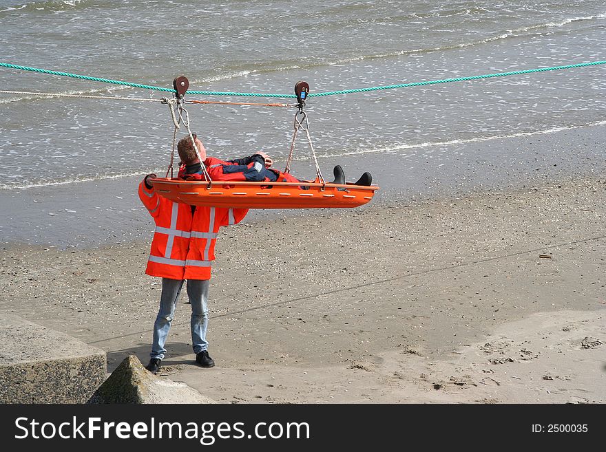 Rescue team doing an excercise on the beach. Rescue team doing an excercise on the beach