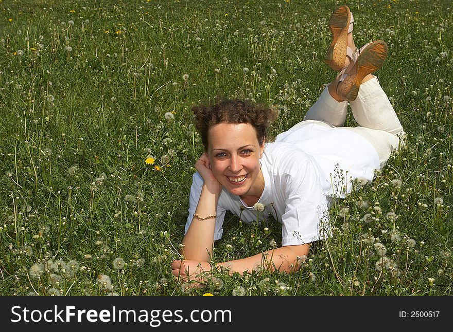Young nice girl lays on a green grass. Young nice girl lays on a green grass