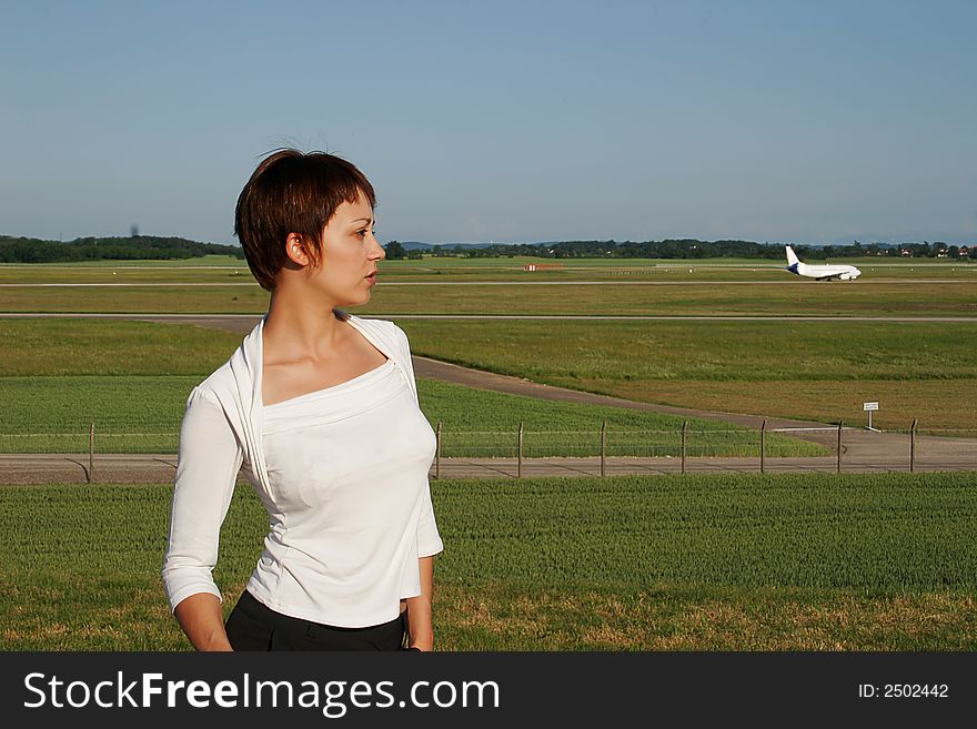 Portrait of a woman looking at a transport aircraft. Portrait of a woman looking at a transport aircraft