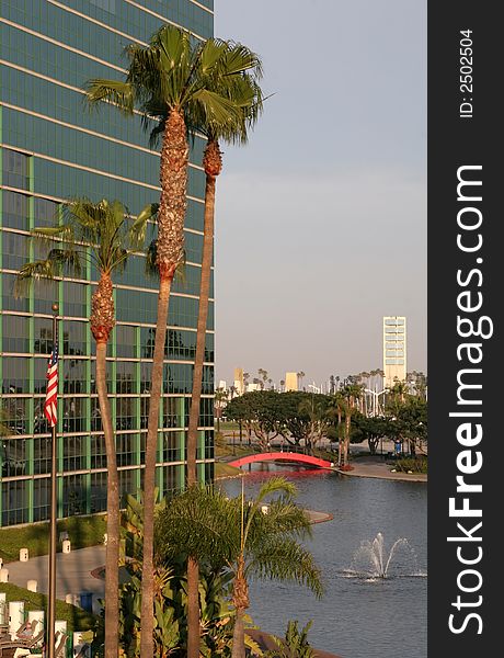 A glass building with American flag and water fountain. A glass building with American flag and water fountain