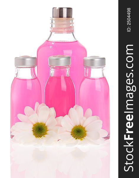 Spa bottles and daisies isolated on white background. Spa bottles and daisies isolated on white background