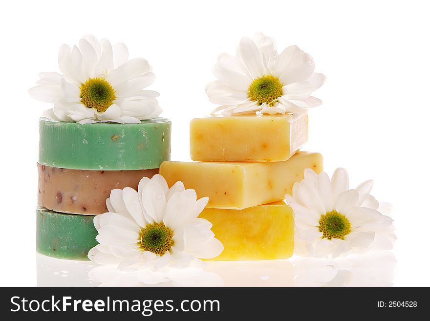 Soap bars and daisies isolated on white. Soap bars and daisies isolated on white