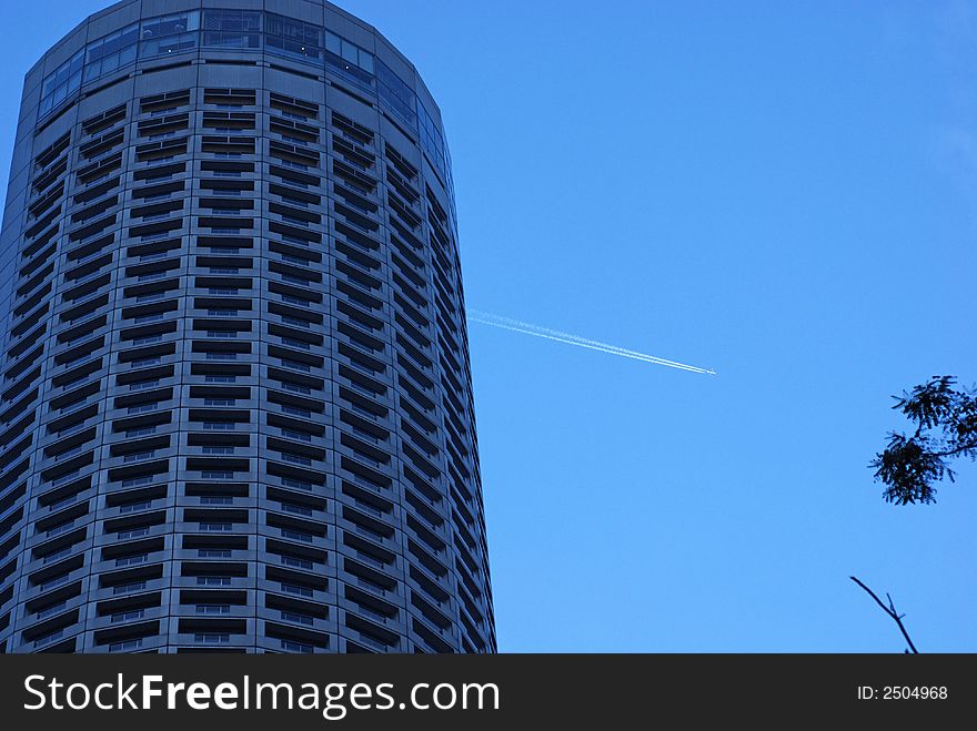 Skyscraper and aeroplane in the skies