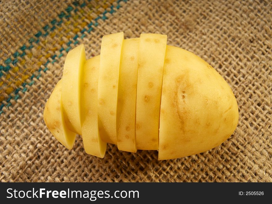 Fresh single young potatoes on burlap