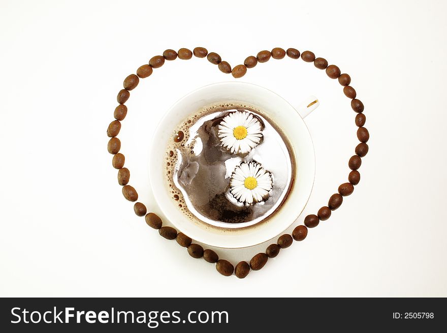 Coffee beans, hearts frame and cup of coffee