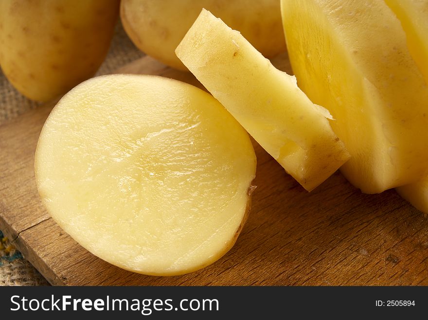 Fresh young potatoes on wood