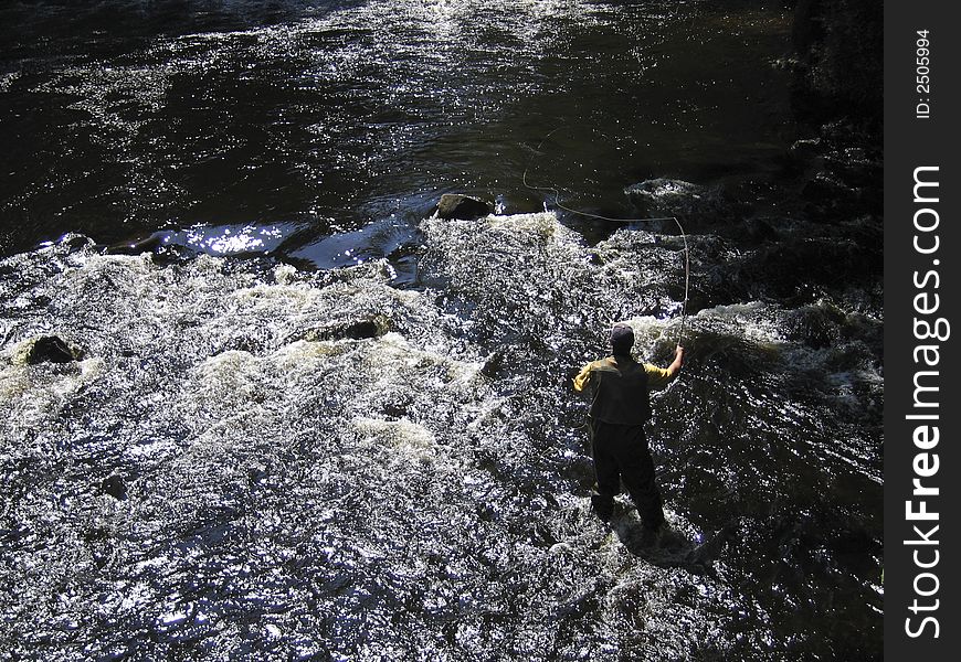 Angler fly fishing, Pepperell, Massachusetts. Angler fly fishing, Pepperell, Massachusetts