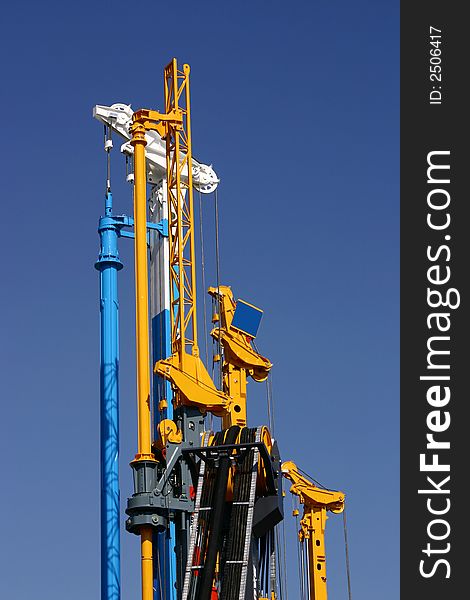 View at construction equipment on a blue sky. View at construction equipment on a blue sky