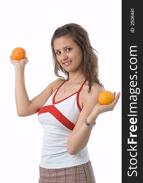 The brown-eyed girl on a white background holds oranges. The brown-eyed girl on a white background holds oranges