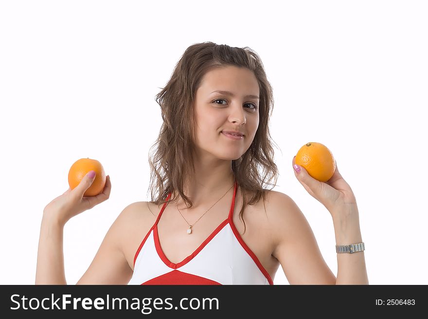 The brown-eyed girl on a white background holds oranges. The brown-eyed girl on a white background holds oranges