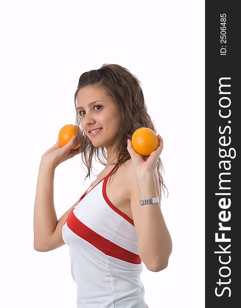 The brown-eyed girl on a white background holds oranges. The brown-eyed girl on a white background holds oranges