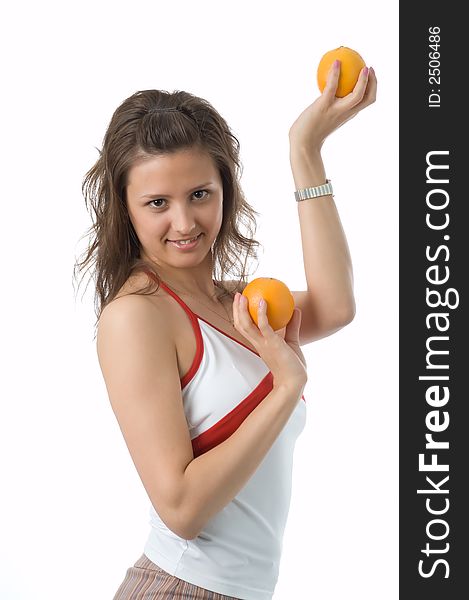 The brown-eyed girl on a white background holds oranges. The brown-eyed girl on a white background holds oranges