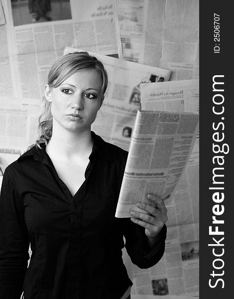 Portrait of a fresh and beautiful blond woman with a lot of newspapers. Portrait of a fresh and beautiful blond woman with a lot of newspapers