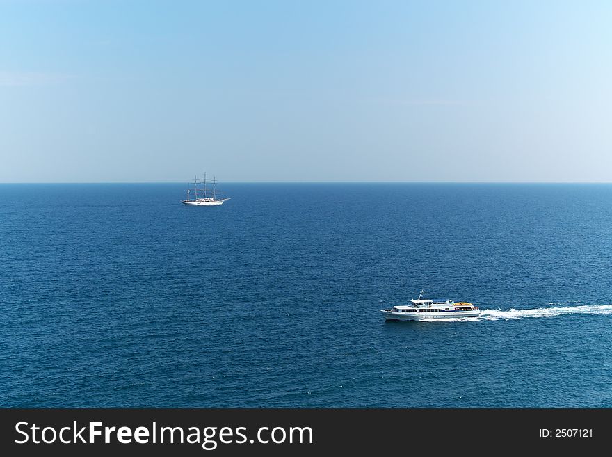 Sail ship and motor cruise boat alone in blue sea. Sail ship and motor cruise boat alone in blue sea