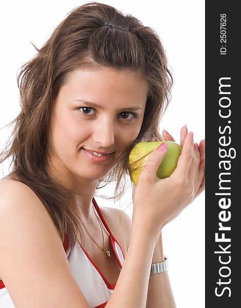 The brown-eyed girl holds a green apple in hands. The brown-eyed girl holds a green apple in hands