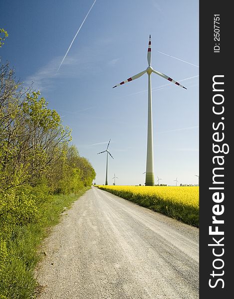 Wind generators with rapeseed fields. A wind turbine is a machine for converting the kinetic energy in wind into mechanical energy. If the mechanical energy is used directly by machinery, such as a pump or grinding stones, the machine is usually called a windmill. If the mechanical energy is then converted to electricity, the machine is called a wind generator. Rapeseed oil is used in the manuf. Wind generators with rapeseed fields. A wind turbine is a machine for converting the kinetic energy in wind into mechanical energy. If the mechanical energy is used directly by machinery, such as a pump or grinding stones, the machine is usually called a windmill. If the mechanical energy is then converted to electricity, the machine is called a wind generator. Rapeseed oil is used in the manuf