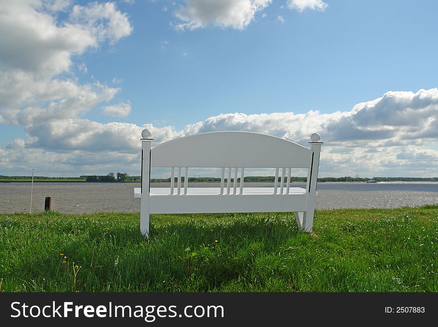 Bench on a dike at a river