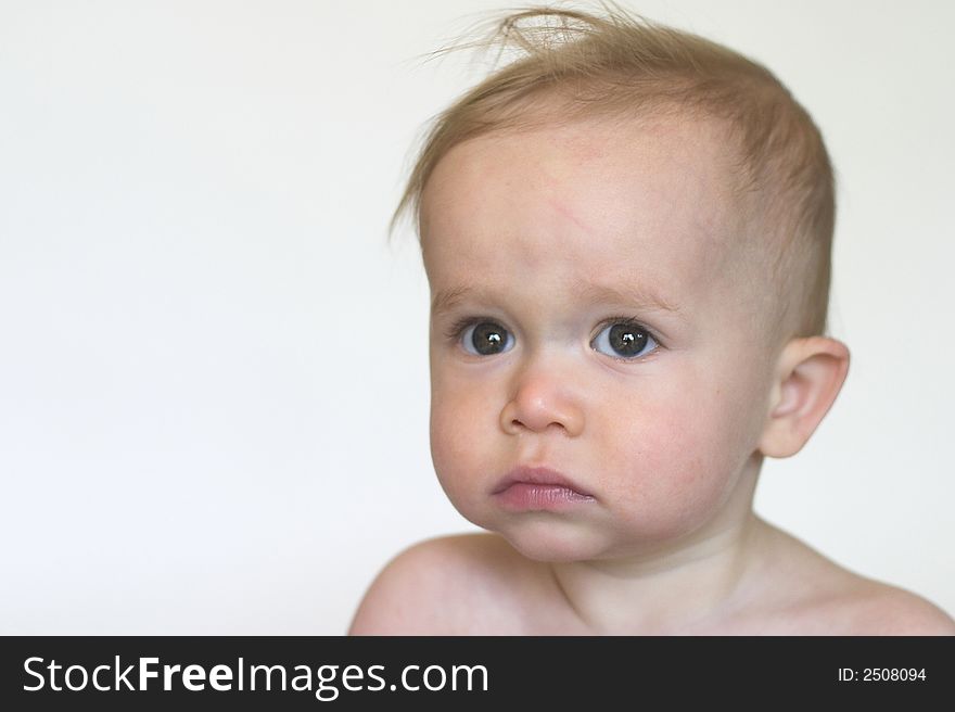 Image of beautiful toddler with a serious look on his face. Image of beautiful toddler with a serious look on his face