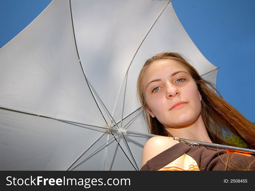 Girl with  white umbrella on  background of  dark blue sky. Girl with  white umbrella on  background of  dark blue sky
